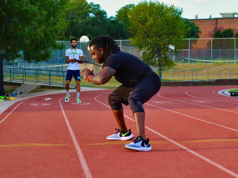 two people on a track with strength and conditioning