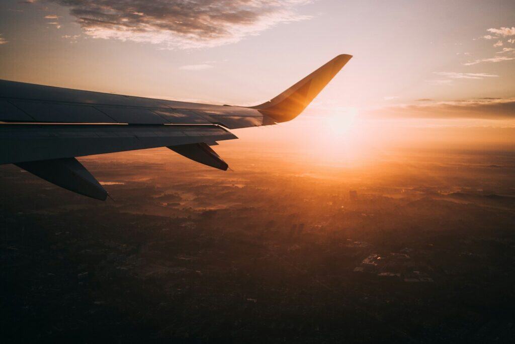The Travelling Athlete: 10 Essential Tips for Competing and Training Abroad 2 Airplane on sky during golden hour