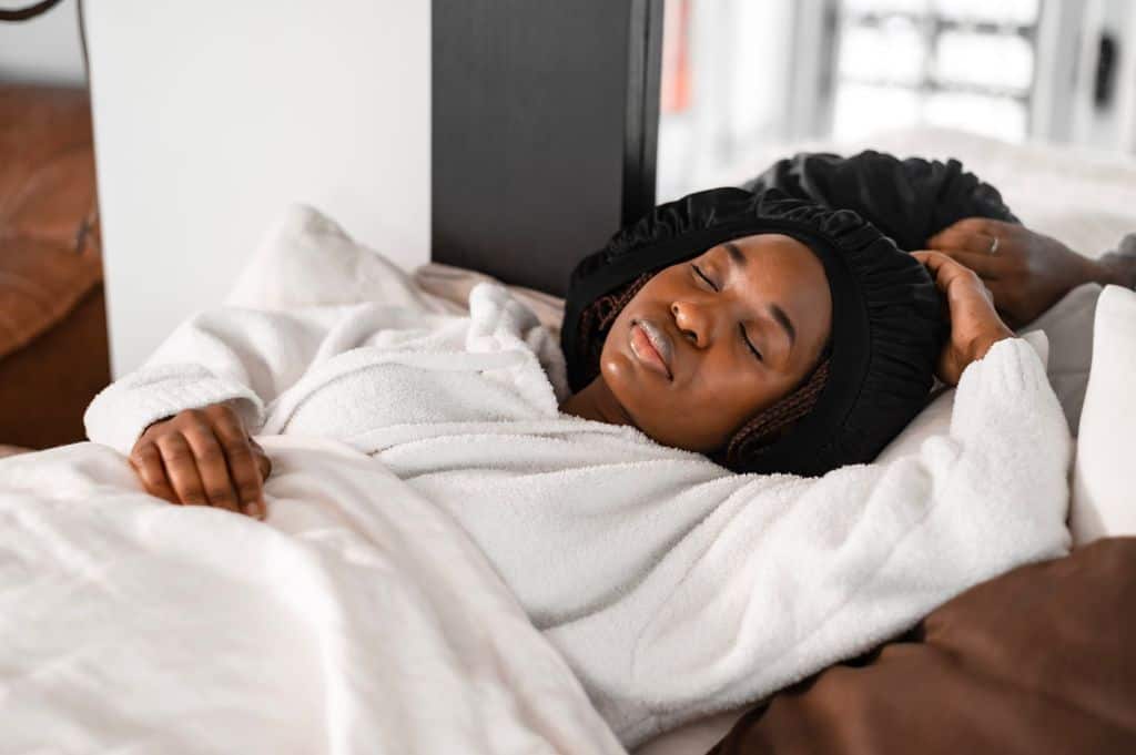What Are the Symptoms of Jet Lag in Athletes? A Practical Guide for Athletes 4 A tranquil scene of a woman sleeping peacefully in a cozy bedroom. Perfect calm moment indoors.