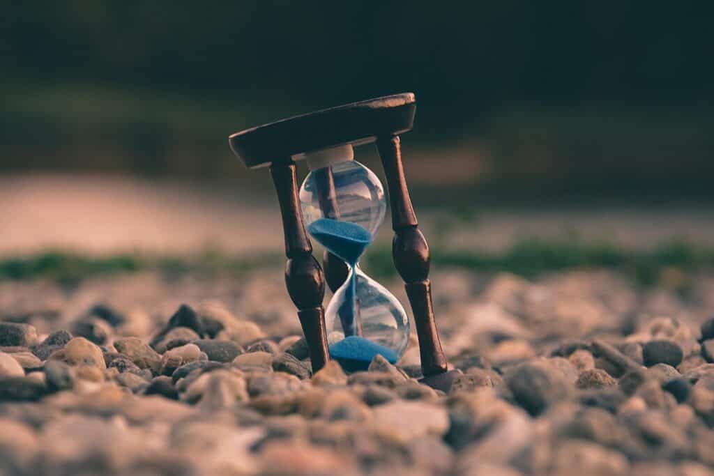 What Are the Symptoms of Jet Lag in Athletes? A Practical Guide for Athletes 3 selective focus photo of brown and blue hourglass on stones