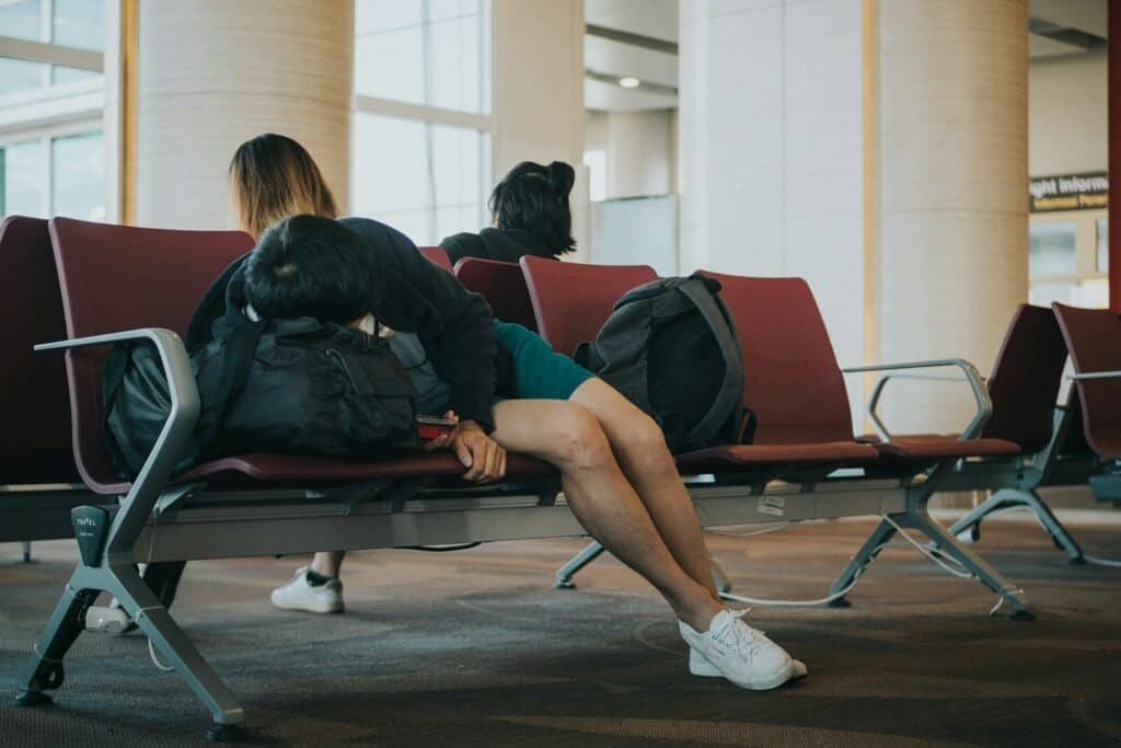 What Are the Symptoms of Jet Lag in Athletes? A Practical Guide for Athletes 7 unknown person lying on brown bench indoors